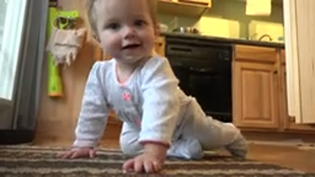 WESTMINSTER COLORADO-2015: Toddler Girl Crawling on Rug in Kitchen Towards Camera