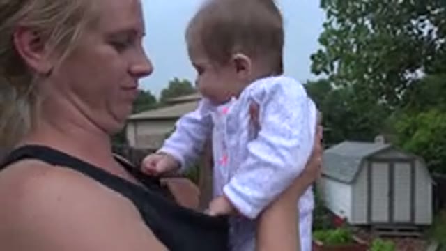 WESTMINSTER COLORADO-2015: A Blonde Woman With Tied Hair Wearing A Black Blouse Carries Her Baby