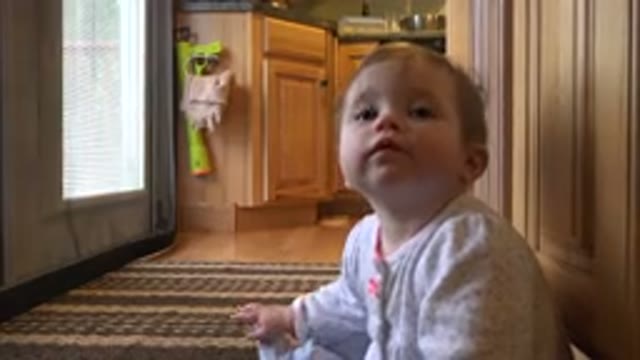 WESTMINSTER COLORADO-2015: A Child Is Sitting On The Floor And Staring At The Camera