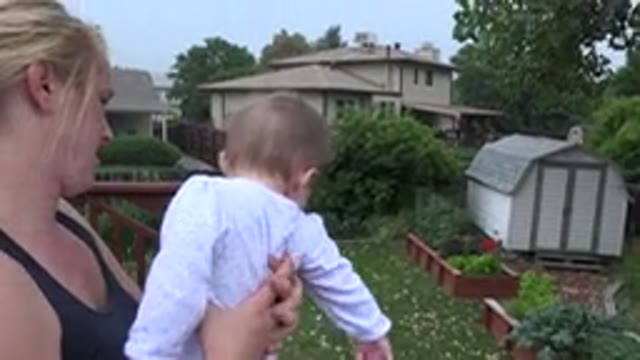 WESTMINSTER COLORADO-2015: The Mother Holds Her Child Outside In The Garden