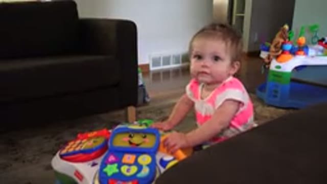 WESTMINSTER COLORADO-2015: A Toddler Girl Leaning On An Electronic Playset