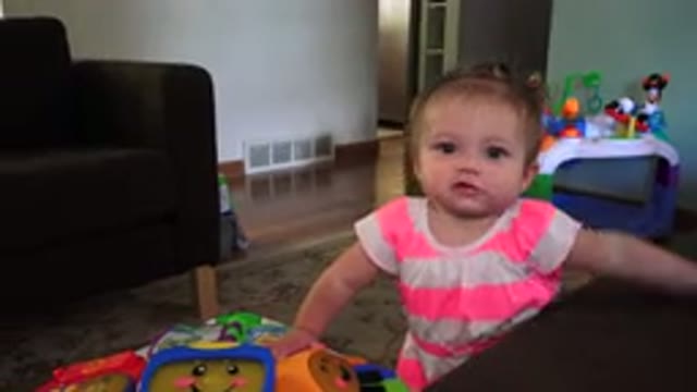 WESTMINSTER COLORADO-2015: Little Girl Learning To Walk While Holding Coffee