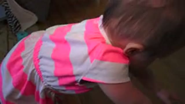 WESTMINSTER COLORADO-2015: Cute Little Girl In A Pink And White Dress Playing On