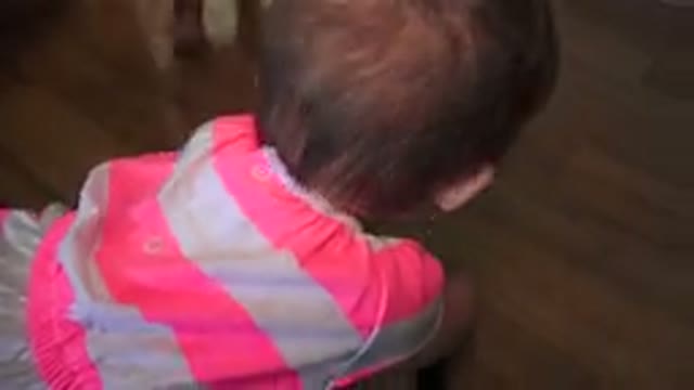 WESTMINSTER COLORADO-2015: Baby Girl Playing On A Wooden Floor Of A House