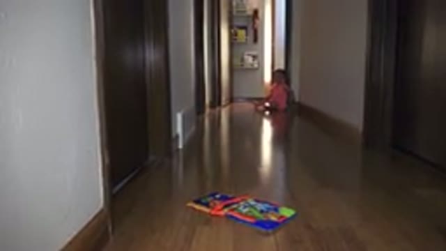 BROOMFIELD COLORADO-2015: A Little Girl Sitting At The End Of A Hallway Within A