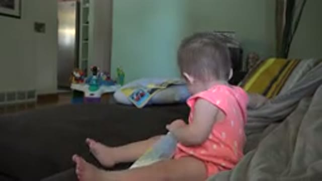 BROOMFIELD COLORADO-2015: Baby Sitting On A Couch In A Room And Looking Around