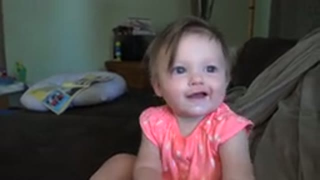 BROOMFIELD COLORADO-2015: Child Happily Drinking Milk While Laughing With Parent