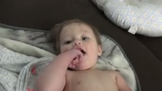 WESTMINSTER COLORADO-2015: A Smiling Happy Toothless Baby With No Shirt Lying On
