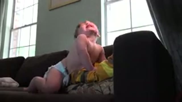 WESTMINSTER COLORADO-2015: Baby Playing On Home Sofa Smiling And Having Fun