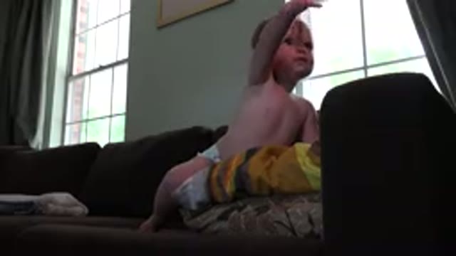 WESTMINSTER COLORADO-2015: Small Child Plays On The Couch And Communicates With