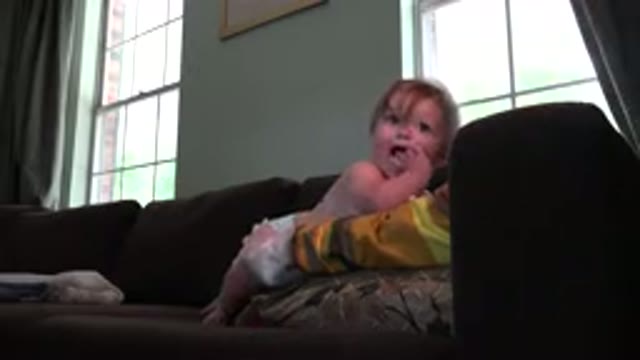 WESTMINSTER COLORADO-2015: Infant Toddler Plays On The Couch While Mom Watches