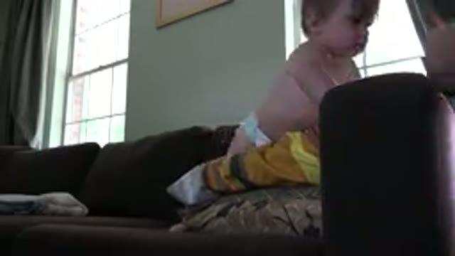 WESTMINSTER COLORADO-2015: A Baby With Blond Hair Wearing Diaper Plays On A Sofa