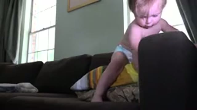 WESTMINSTER COLORADO-2015: Child in Diaper Playing on Sofa with Cushions
