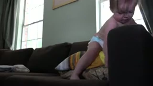 WESTMINSTER COLORADO-2015: A Diaper Clad Toddler Standing On A Sofa Pressing Buttons