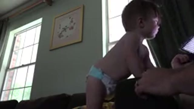 WESTMINSTER COLORADO-2015: Toddler In Diapers Watches Electronic Device On Couch