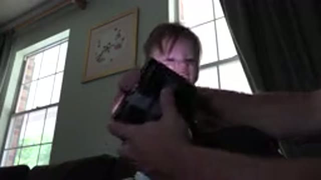 WESTMINSTER COLORADO-2015: Small Child Playing With Parent And Flashlight On The Sofa