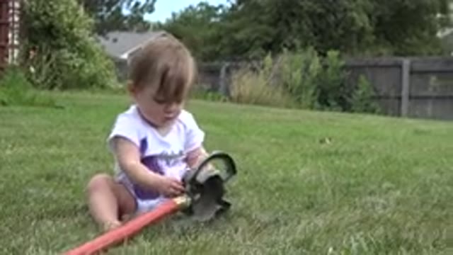 WESTMINSTER COLORADO-2015: Blond Baby Girl Playing With Springier Sitting On The Grass