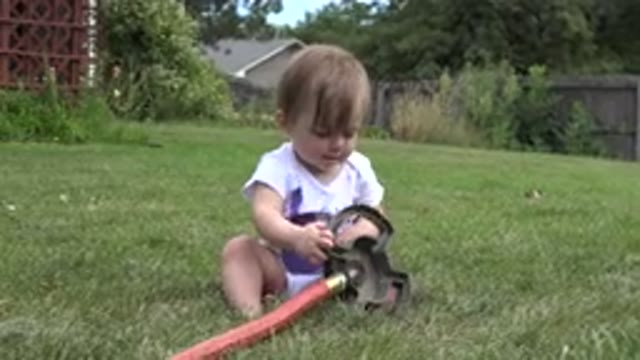 WESTMINSTER COLORADO-2015: Baby Girl Sitting In A Yard And Playing With Toys
