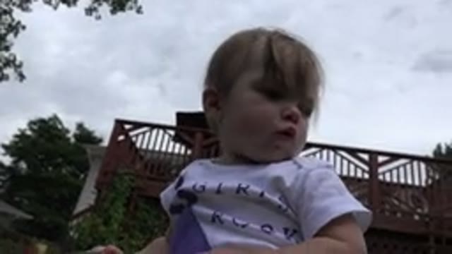 WESTMINSTER COLORADO-2015: A Child With Blonde Hair Turns Their Head And Sticks Tongue Out