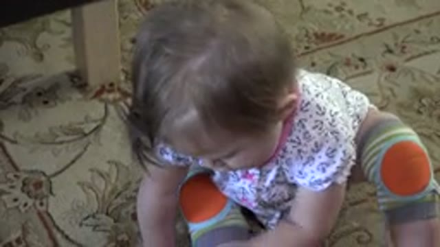WESTMINSTER COLORADO-2015: Caucasian Baby With Brown Hair Playing With Green Toy