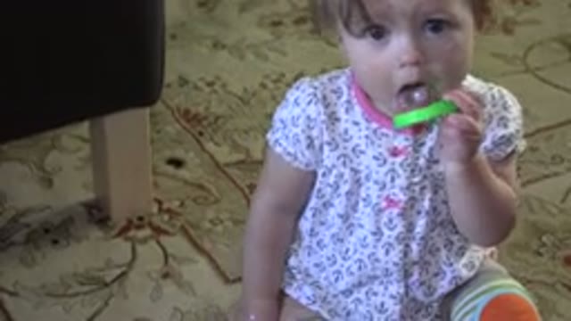 WESTMINSTER COLORADO-2015: Toddler Biting And Eating Her Green Circular Toy