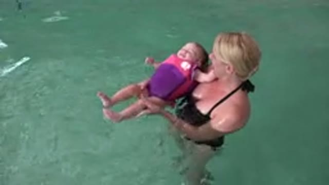 WESTMINSTER COLORADO-2015: Mother Teaching Small Adorable Baby How To Swim In A