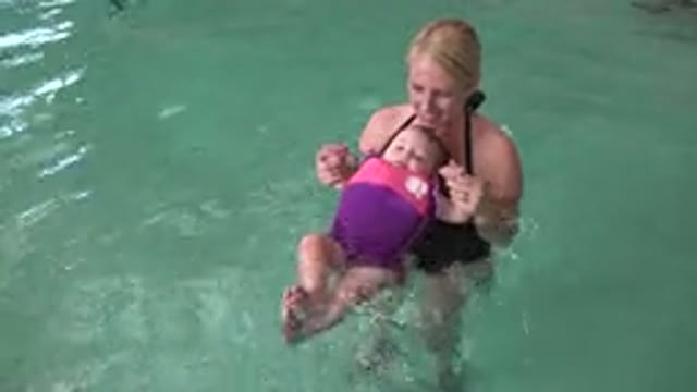 WESTMINSTER COLORADO-2015: Woman Teaching A Baby Wearing Life Vest How To Float