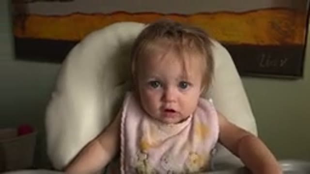 HIDDEN LAKE COLORADO-2015: Cute Baby With A Bib Looking At Her Parents And