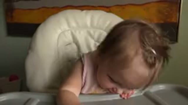 HIDDEN LAKE COLORADO-2015: A Little Girl Sat In A High Chair Tapping It