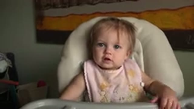 HIDDEN LAKE COLORADO-2015: Baby Weaning Bib Sits In Highchair Communicating With