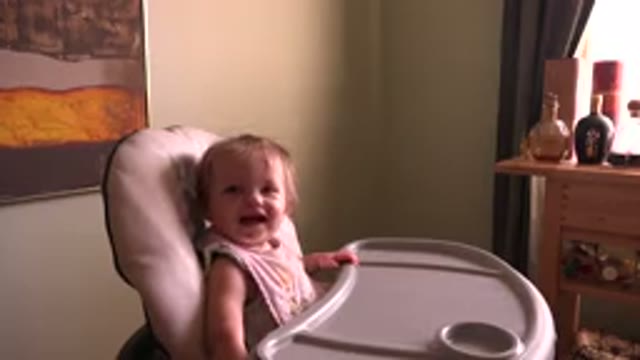 HIDDEN LAKE COLORADO-2015: A Smiling Cute Little Baby Girl Sitting On A Highchair