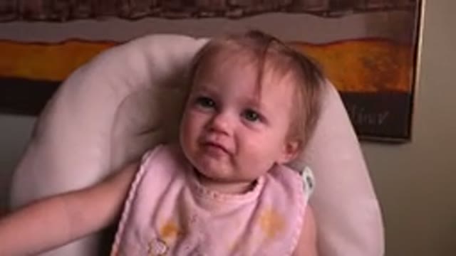 HIDDEN LAKE COLORADO-2015: Baby Staring While Eating In High Chair And Looking
