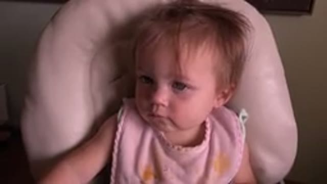 HIDDEN LAKE COLORADO-2015: Little Girl Blinking Sitting in Cream Chair Pink