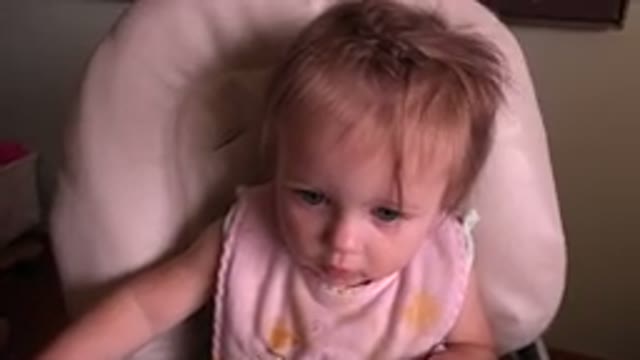 HIDDEN LAKE COLORADO-2015: A Cute Blond Baby Sits Alone in a Highchair Smiling