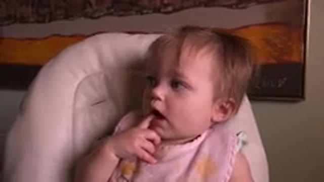 HIDDEN LAKE COLORADO-2015: Small Toddler Wearing Pink Bib Sucking Index Finger