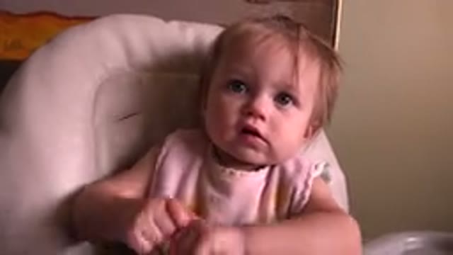 HIDDEN LAKE COLORADO-2015: Cute Curious Little Girl Sitting On A Highchair