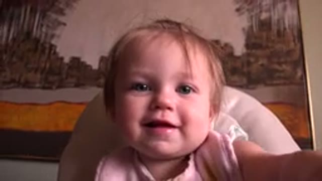 HIDDEN LAKE COLORADO-2015: A Baby Sitting In A Chair Looking Into The Camera And Smiling