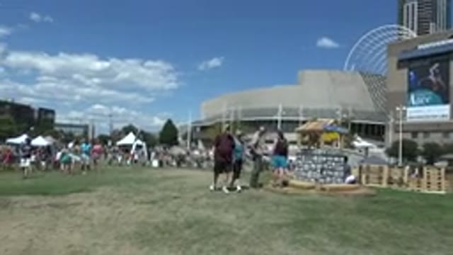 DENVER COLORADO-2015: Small Crowd Of People Attending A Summer Exhibition In A Field
