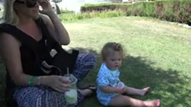 DENVER COLORADO-2015: Child Plays With A Tabby Cat In The Park