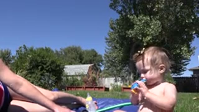 WESTMINSTER COLORADO-2015: Child Splashing in Water with Woman Outdoors