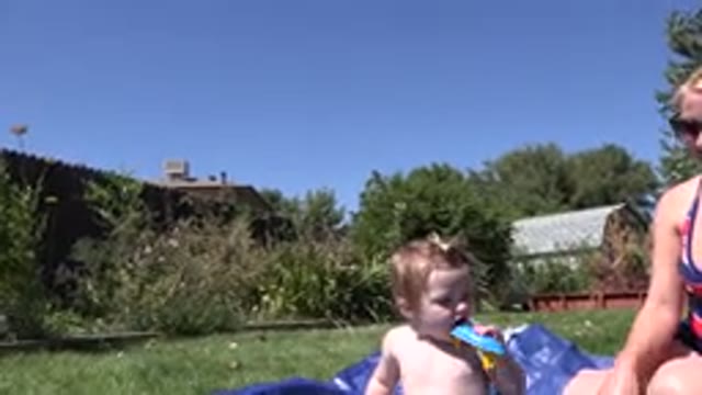 WESTMINSTER COLORADO-2015: A Woman In A Bathing Suit And Her Child Relaxing In A