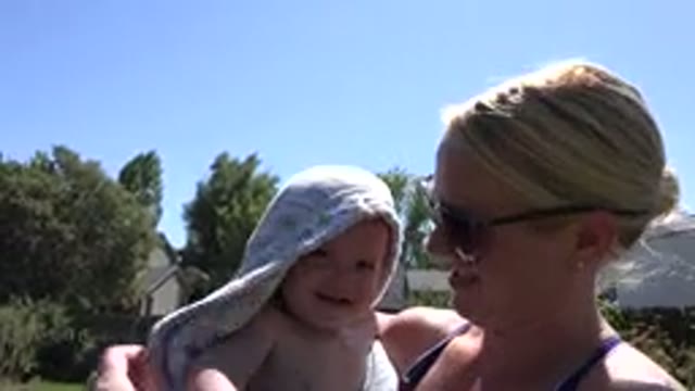 WESTMINSTER COLORADO-2015: Woman Wearing Sunglasses Wraps Baby In Blue And White