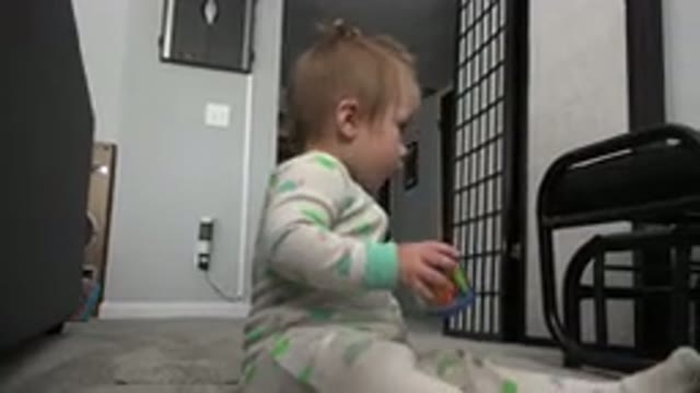 WESTMINSTER COLORADO-2015: A Cute Little Girl Sitting On The Floor And Playing