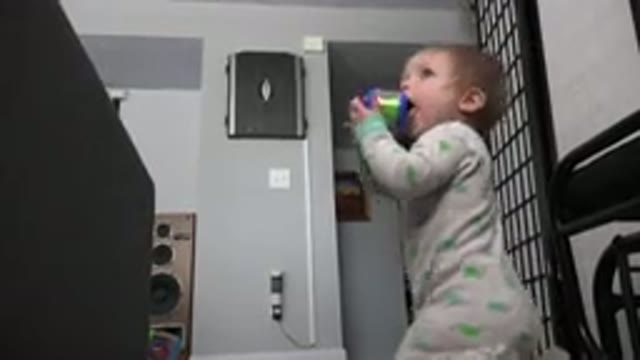WESTMINSTER COLORADO-2015: Infant Wearing Green and White Sleeper Chews on Small Object