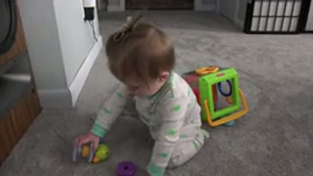 WESTMINSTER COLORADO-2015: Blonde Baby Girl Playing With Toys Sitting On Carpet