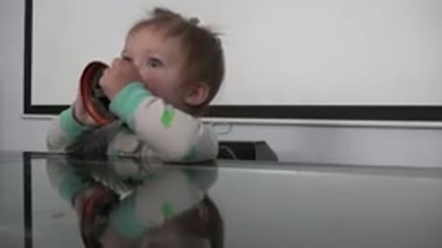 WESTMINSTER COLORADO-2015: Baby And Man Playing With Bell On The Glass Table