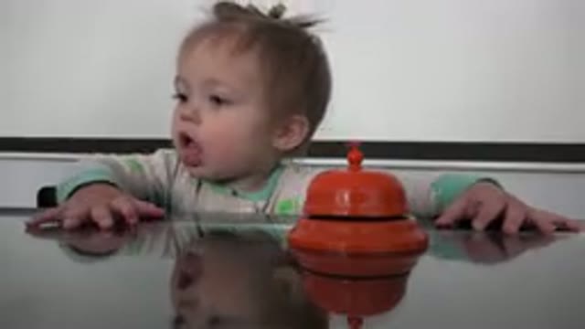 WESTMINSTER COLORADO-2015: Blond White Child Sitting At A Table Playing With An Orange Bell