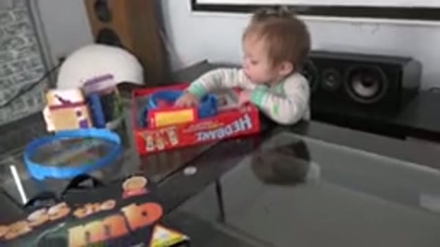 WESTMINSTER COLORADO-2015: Young Baby Girl Playing With Board Games While Parent