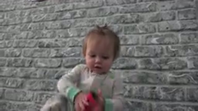 WESTMINSTER COLORADO-2015: Curious Baby In Pajamas Playing With Card In Front Of Brick Wall