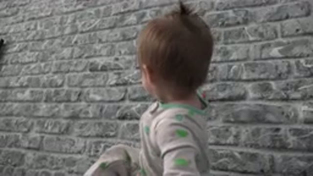 WESTMINSTER COLORADO-2015: A Child Plays With a Toy Car Against a Wall